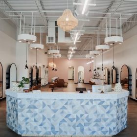 Front view of reception desk and salon layout with Freestylist dryers and light platforms