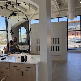 Modern hair salon styling stations with ceiling-mounted Freestylist dryers in Longmont Colorado